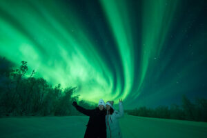 Northern lights over a winter landscape during a Lapland holiday in Finland
